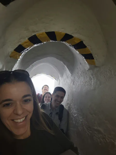 A group selfie on a narrow spiral staircase.