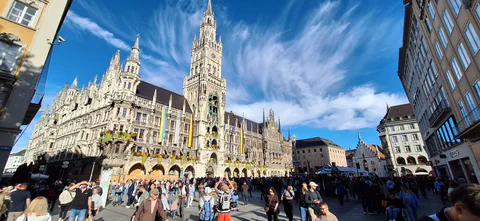 A panoramic view of a busy square and ornate buildings in central Munich.